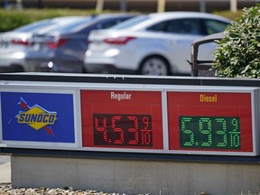 FILE - Gas prices are displayed at a Sunoco gas station along the Ohio Turnpike near Youngstown, Ohio, Tuesday, July 12, 2022. U.S. consumer confidence slid again in July 2022, as concerns about higher prices for food, gas and just about everything else continued to weigh on Americans. The Conference Board said Tuesday, July 26, 2022, that its consumer confidence index fell to 95.7 in July from 98.4 in June, largely due to consumers' anxiety over the current conditions, particularly four-decade high inflation.